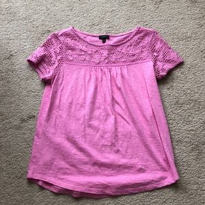 Pink top with lace sleeves.